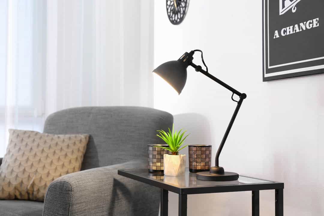 Living room interior with modern lamp on table and comfortable a